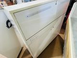 two white cabinets in the middle of a room