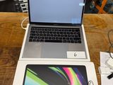two laptops sitting on a table next to each other