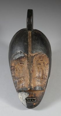 an image of a wooden mask with a cross on it