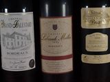 several bottles of wine are lined up on a table