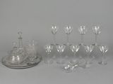 a lot of wine glasses and a tray on the table