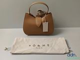 a brown purse sitting on top of a white table next to a bag
