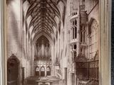 an old photo of a church with a bench in the middle of it