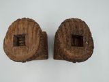 two pieces of wood are sitting on a white surface
