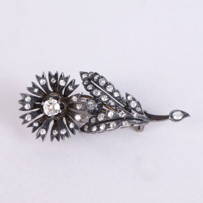 Une image représentant une broche en forme de fleur de diamant est représentée sur un fond blanc.
