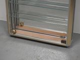 a display case with glass shelves on the floor