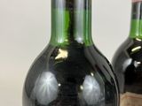 two bottles of wine sitting next to each other on a table