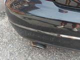 a black car parked on the side of the road with its trunk open