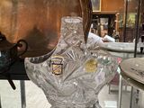 a glass display case with a glass vase on top of it