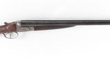 an old rifle with a wooden handle on a white background