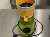 a green and yellow blender sitting on a counter