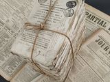 a stack of old newspapers wrapped in twine and tied with twine