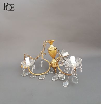 a gold colored chandelier with a bird on it