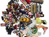 a pile of assorted toys on a white surface