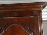 a wooden cabinet with a clock on top of it
