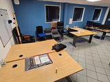 an image of a room with a lot of desks and chairs