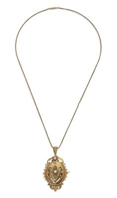 a close up of a necklace with a lion head on it