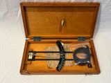a wooden box with a pair of scissors in it