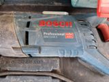 a close up of a bosch electric tool on a table