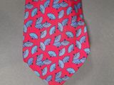 a red neck tie with blue leaves on it
