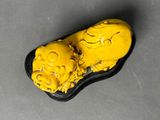 two yellow skulls sitting on top of a black tray on top of a table