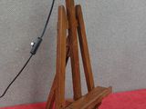 a wooden stand with a lamp on top of it