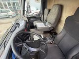 a driver ' s seat and steering wheel of a bus