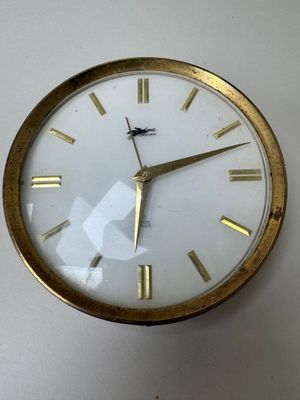 a clock on the wall with roman numerals on it
