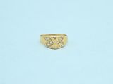 a close up of a gold ring on a white surface