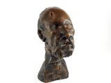 sculpture of a man ' s head on a white surface with a white background