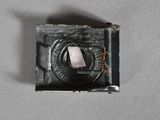 a small metal object with a hole in the middle of it