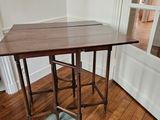 a wooden table with a blue rug on the floor