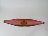 a red glass bottle with a flower inside of it