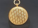 a close up of a gold locke on a black surface