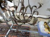 a metal table with a glass candle holder on it