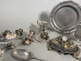 a lot of silver items that are on the table
