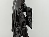 a statue of a man with a hat on a table