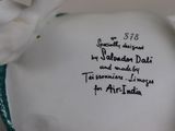 a vase with a bird on it that has a poem written on it