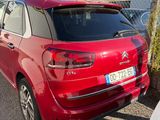the rear end of a red citrole parked in a parking lot