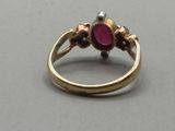 an image of a gold ring with a pink stone
