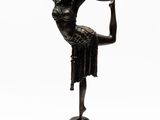 bronze statue of a woman holding a hoop on a black base