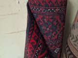two rugs that are hanging up against a wall
