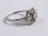 an image of a silver ring with a flower design on it