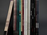 a lot of books that are stacked on top of each other