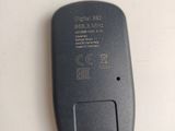 an image of a black remote control on a white surface