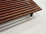 a wooden bench that is sitting on a white floor