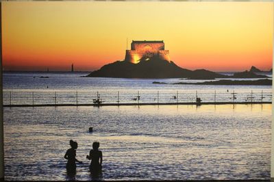 deux personnes qui se tiennent dans l'eau à la plage