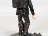 statue of a man with a basket on his head