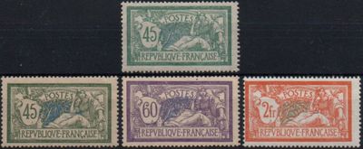 a group of four different colored stamps on a black surface