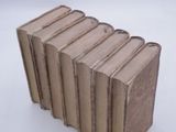 five books stacked on top of each other on a white surface